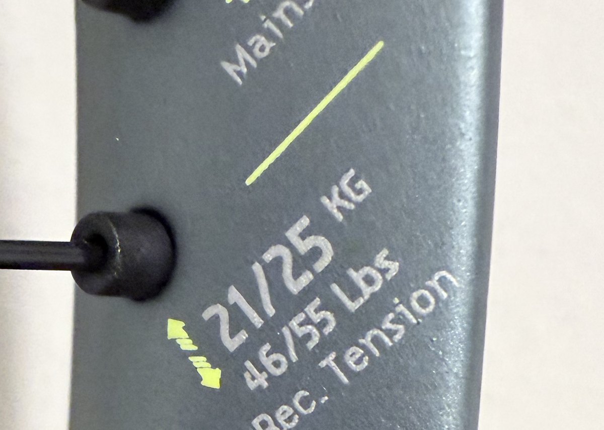 The recommended-tension sticker inside the throat — 46–55 lb (21–25 kg)